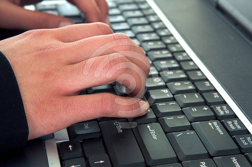 Hands typing on a keyboard