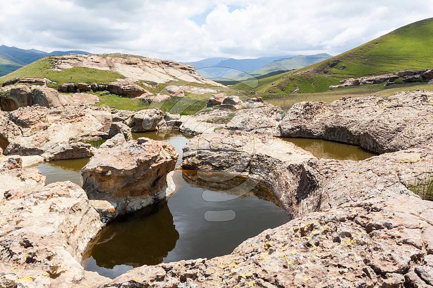 Beautiful water filled holes in rock formations