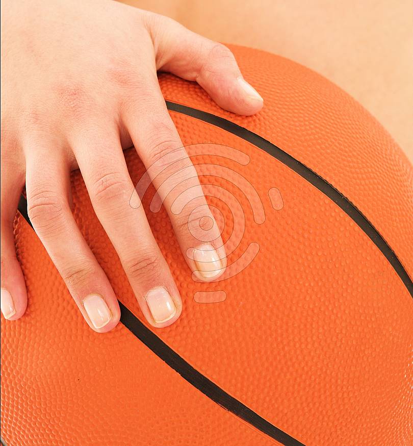 Hand on basketball