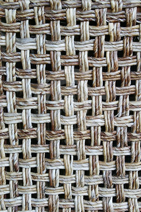 The backrest of a wicker chair